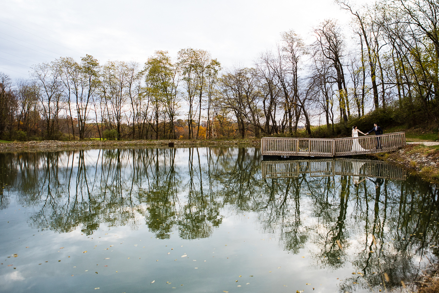 Bride and Groom at Lenape Heights Golf Resort with water and tree reflections, November wedding