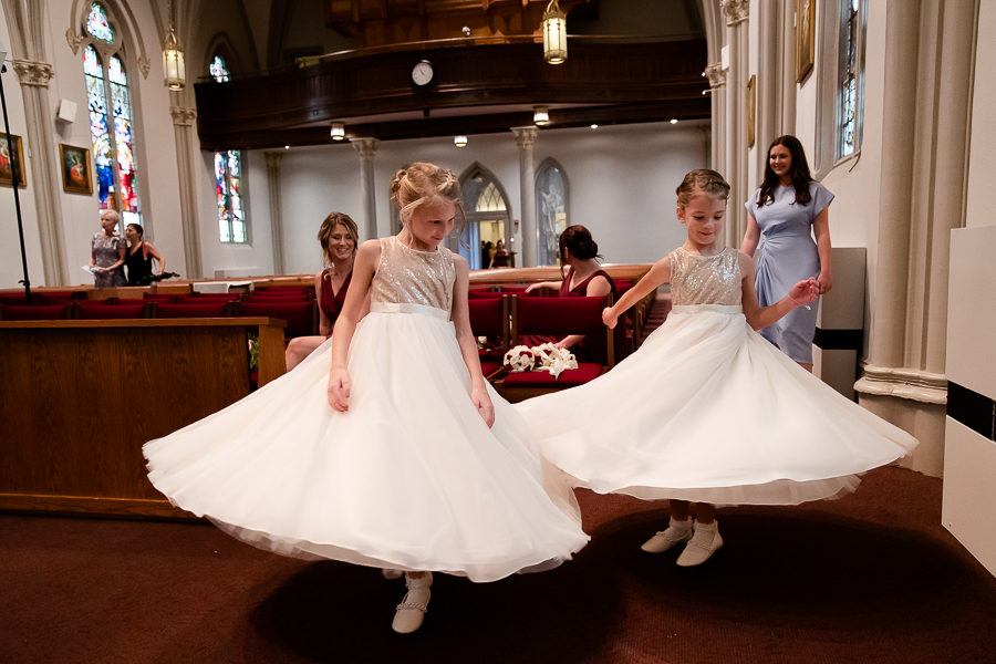 Flower girls twirling in the church