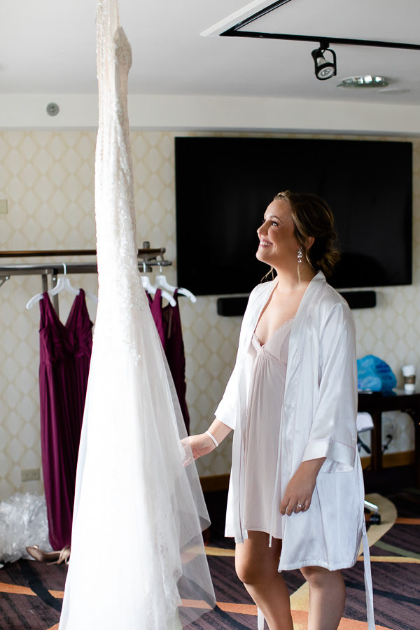 Bride admires her wedding dress